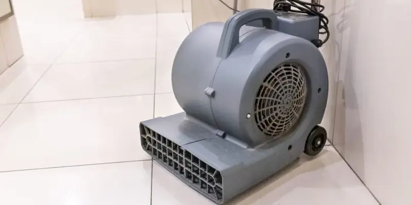 Air mover drying a tile floor after a water leak in Dublin, CA