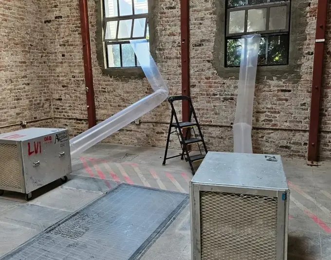 Dehumidifiers and ducting drying a commercial space after water damage in Dublin, CA